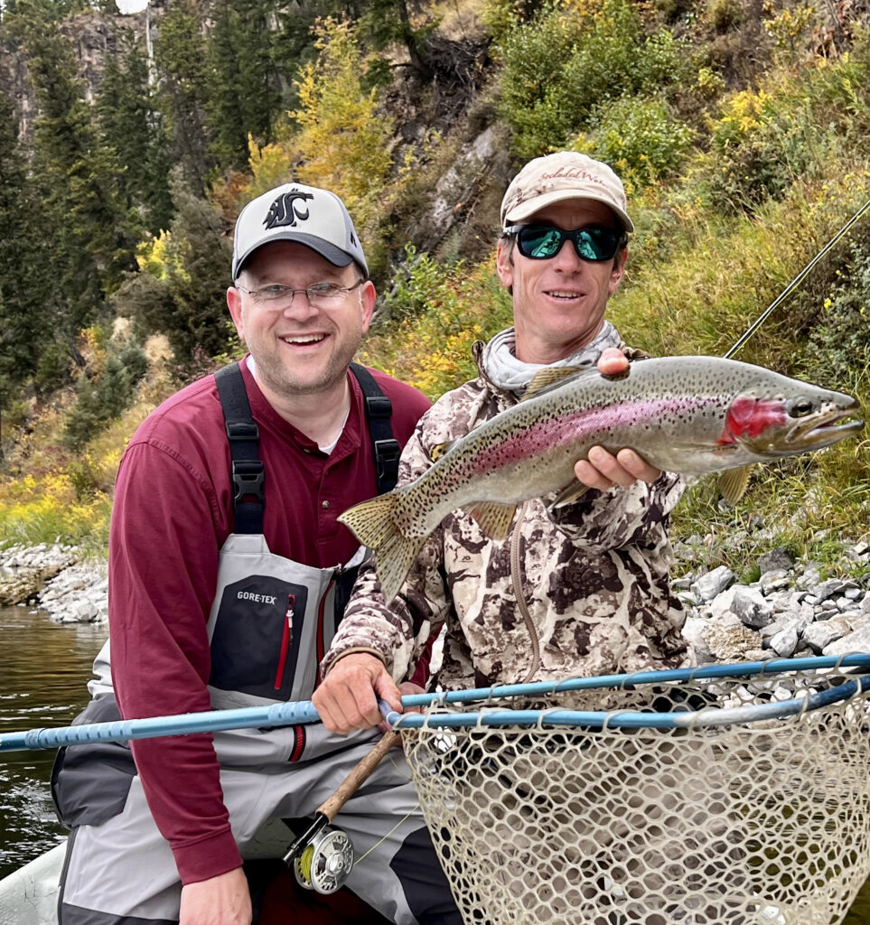 A perfect fall day on the Kootenai River in Idaho. A happy trio: angler, guide and wild rainbow trout.